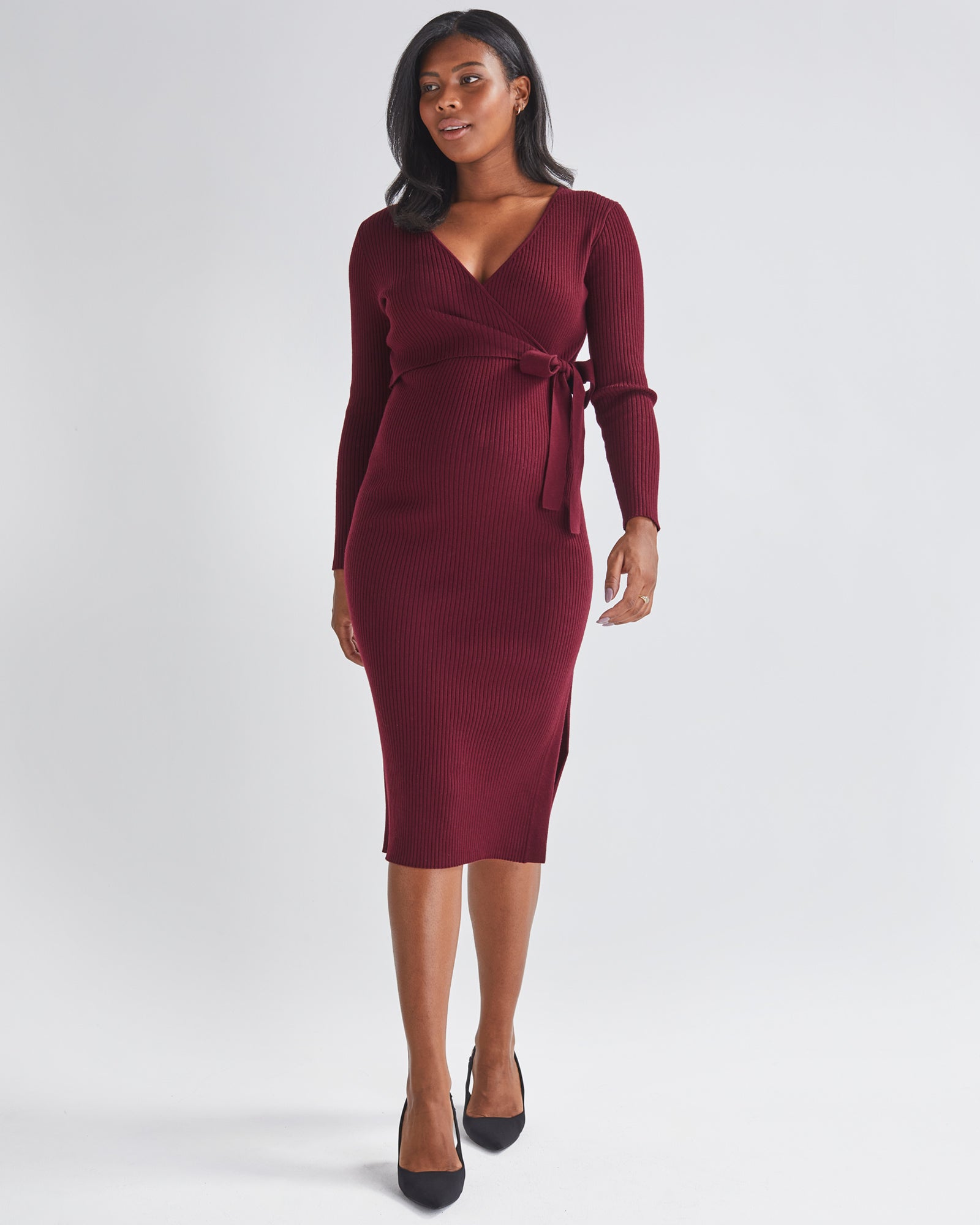 A Pregnannt Woman Wearing Lucille Full Sleeve Knit Maternity Midi Dress in Burgundy from Angel Maternity.