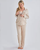Nursing view-A pregnant woman wearing button front nursing freindly pyjama set in pink from Angel Maternity.