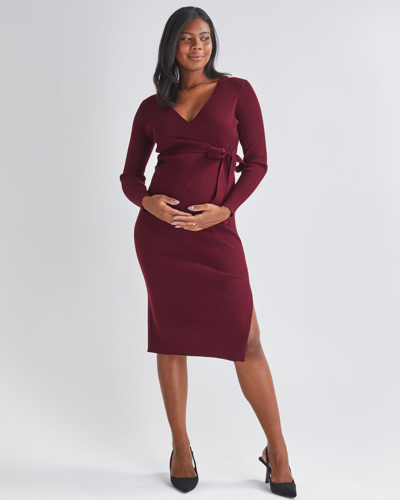 Front View - A Pregnannt Woman Wearing Lucille Full Sleeve Knit Maternity Midi Dress in Burgundy from Angel Maternity.