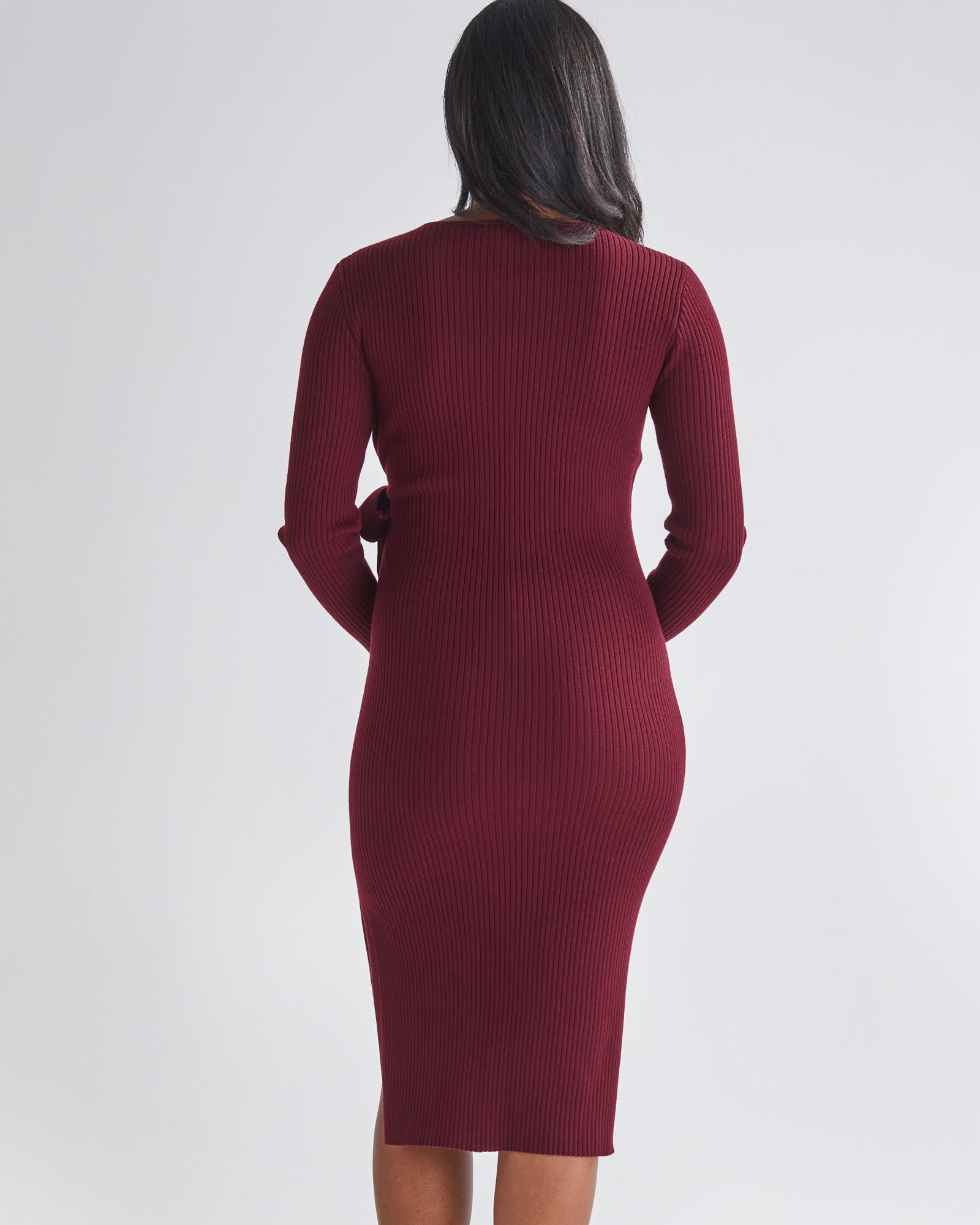 Back View - A Pregnannt Woman Wearing Lucille Full Sleeve Knit Maternity Midi Dress in Burgundy from Angel Maternity.