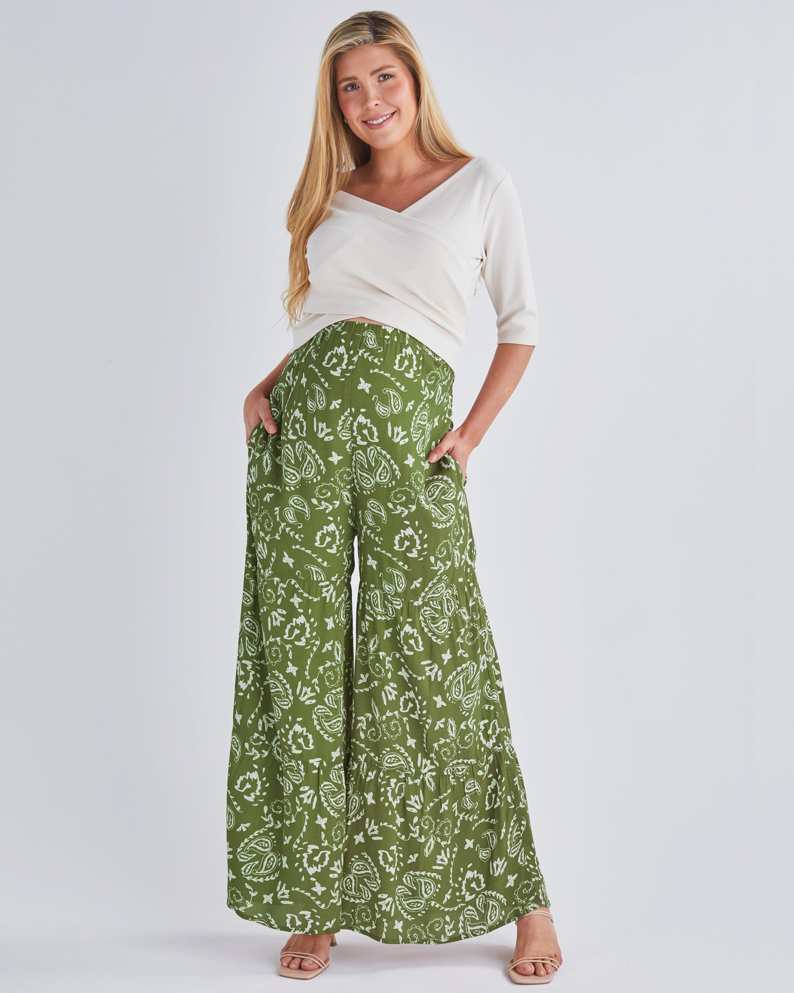 A pregnant Woman Wearing Stacie Wide Leg Khaki Maternity Pants in Paisley Print from Angel Maternity