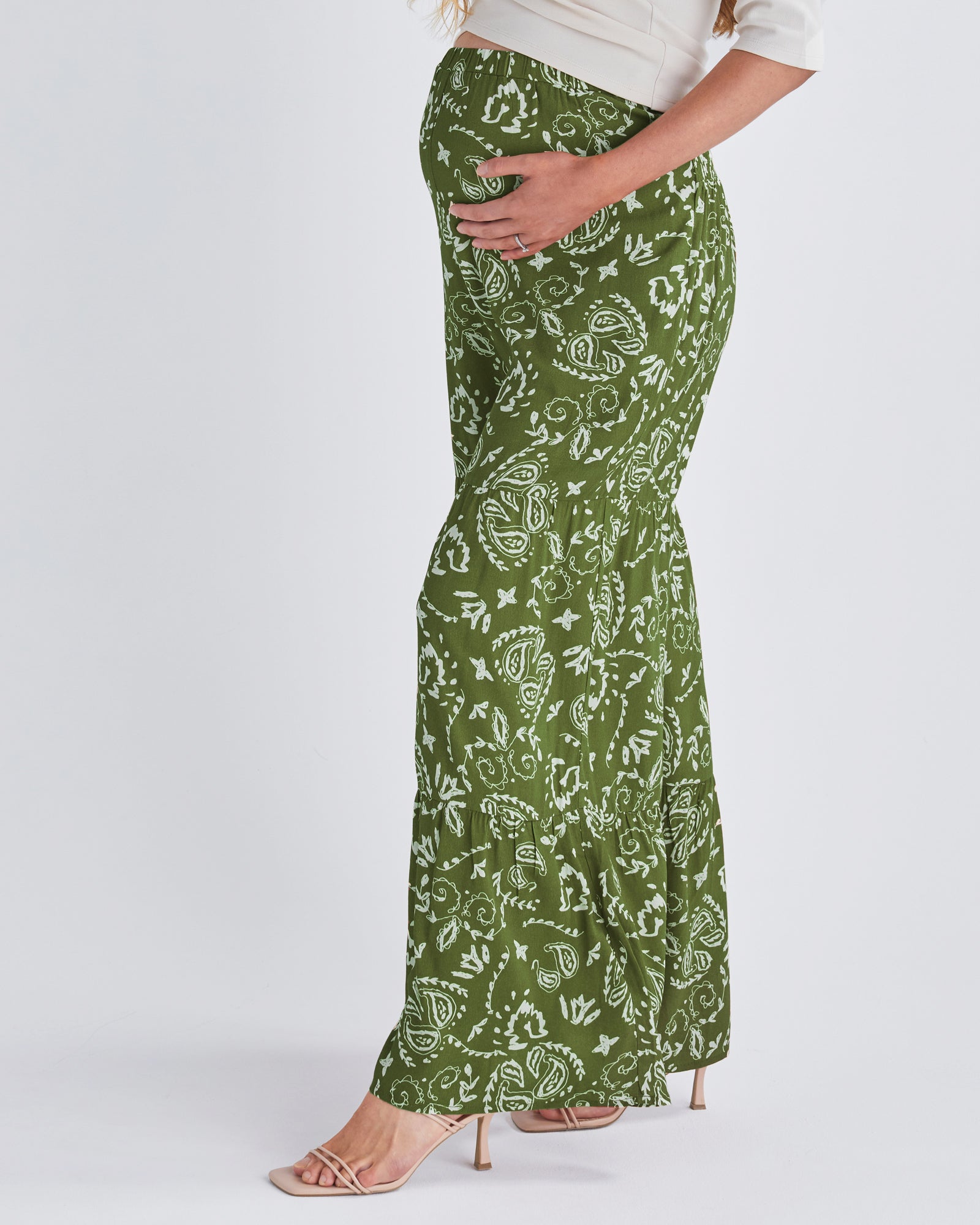 Side View - A pregnant Woman Wearing Stacie Wide Leg Khaki Maternity Pants in Paisley Print from Angel Maternity