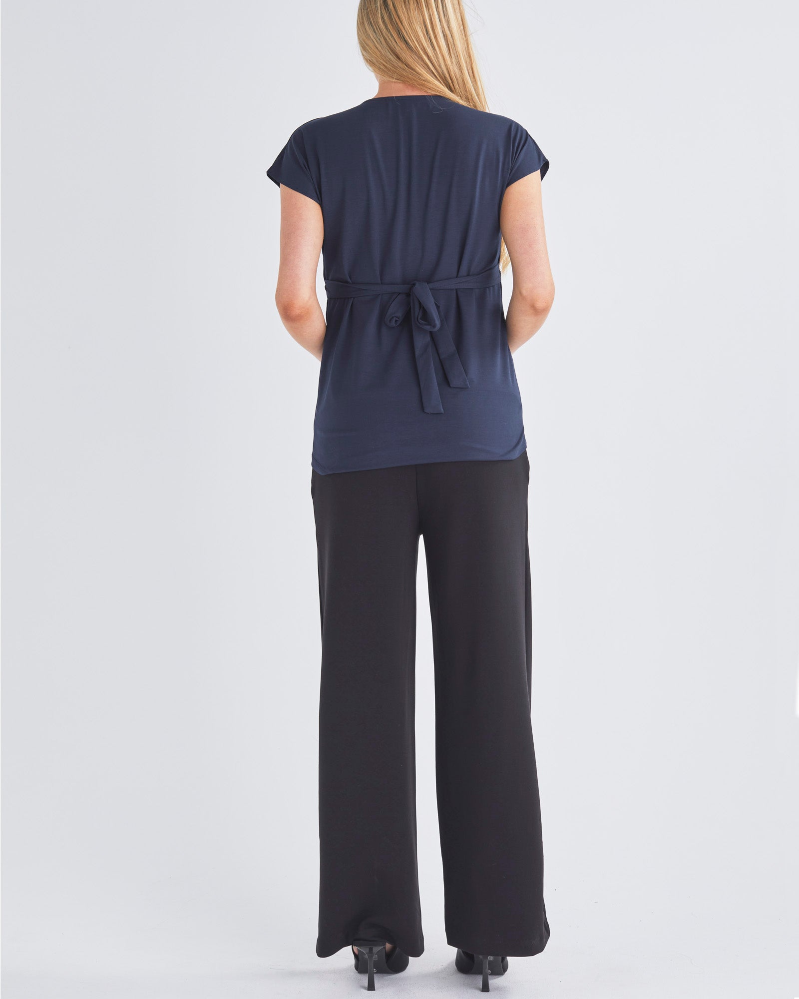 Back View - A Pregnant Woment Wearing Elodie Wide Leg Maternity Black Work Pant in Ponti from Angel Maternity Australia
