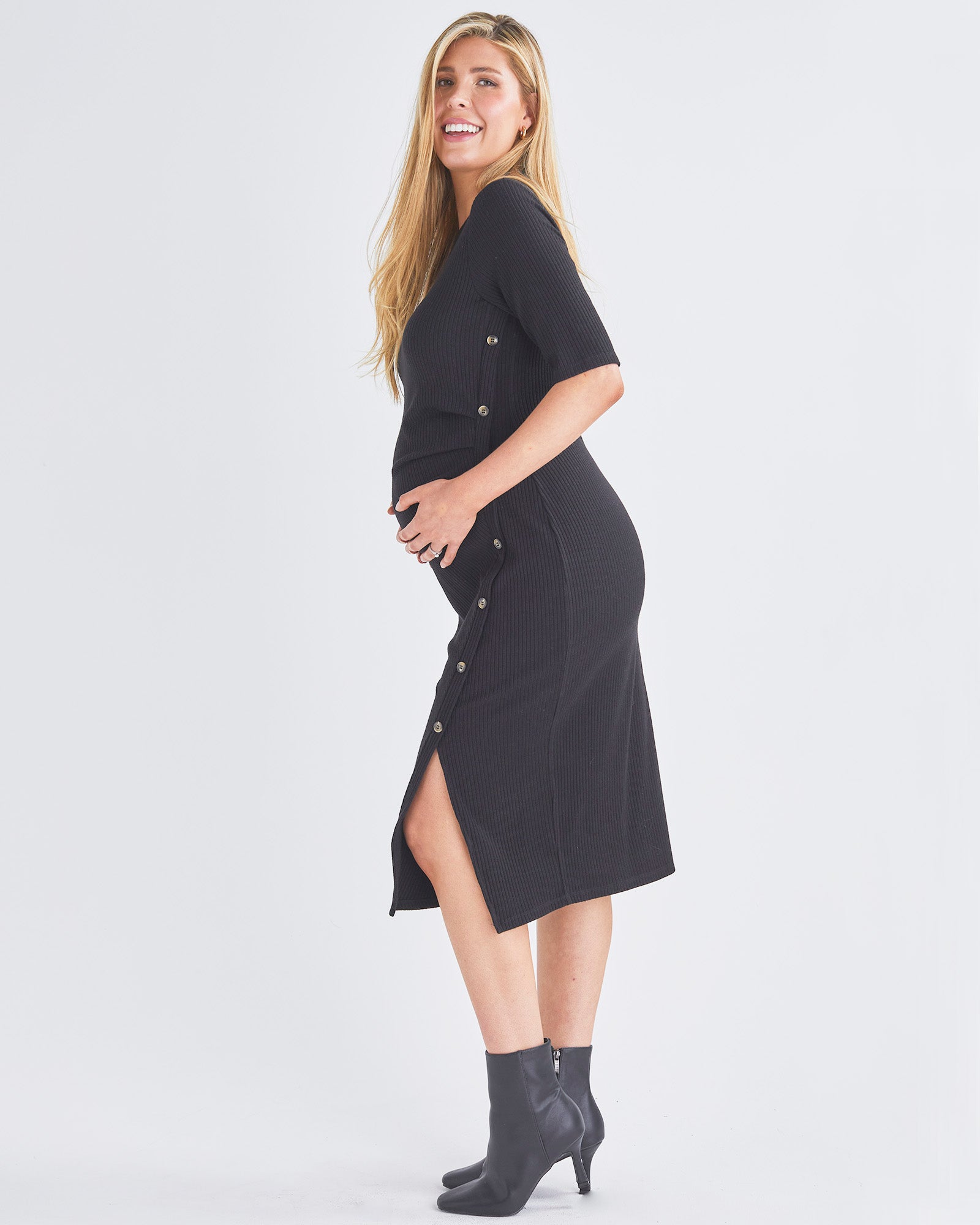 Side View - A Pregnant Woman Wearing Elegant Maternity Black Bodycon Dress from Angel Maternity