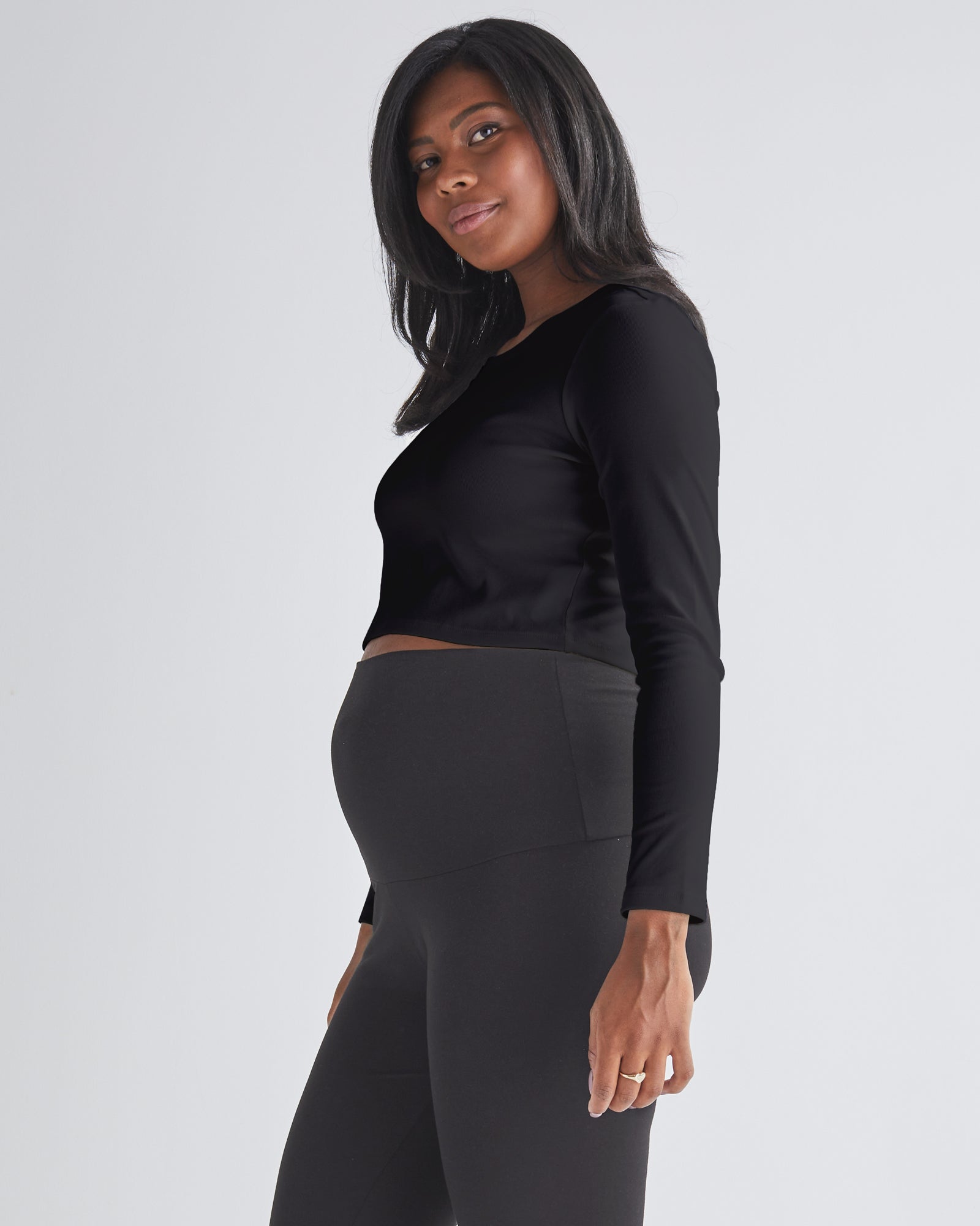 A Pregnant Woman Wearing Long Sleeve Cotton Black Maternity Crop Top from Angel Maternity