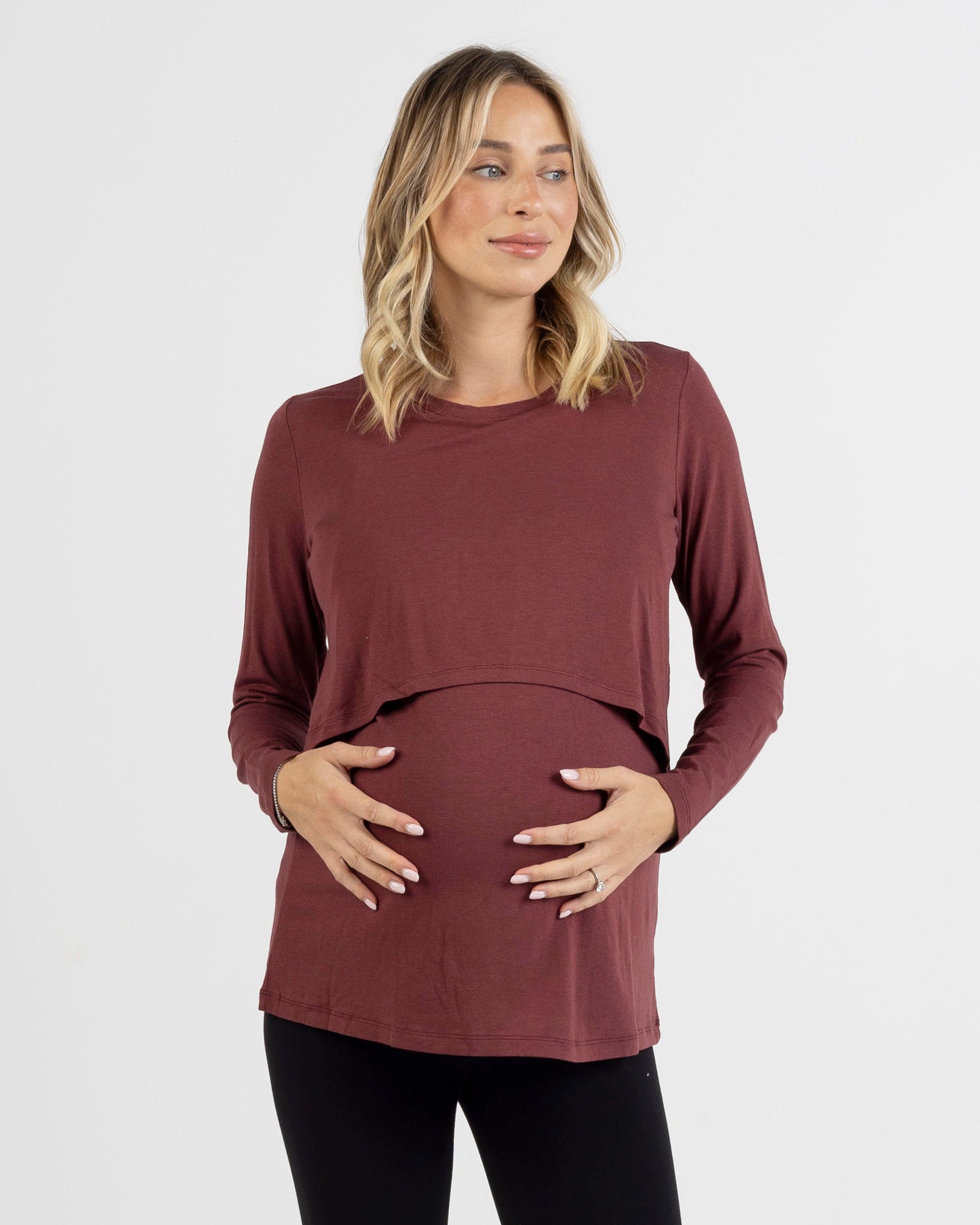 Pregnant Woman wearing a maroon long-sleeve nursing top on a white background