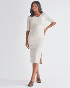 A Pregnant Woman Wearing Athena Maternity Pencil Midi Skirt in Oat Milk from Angel Maternity