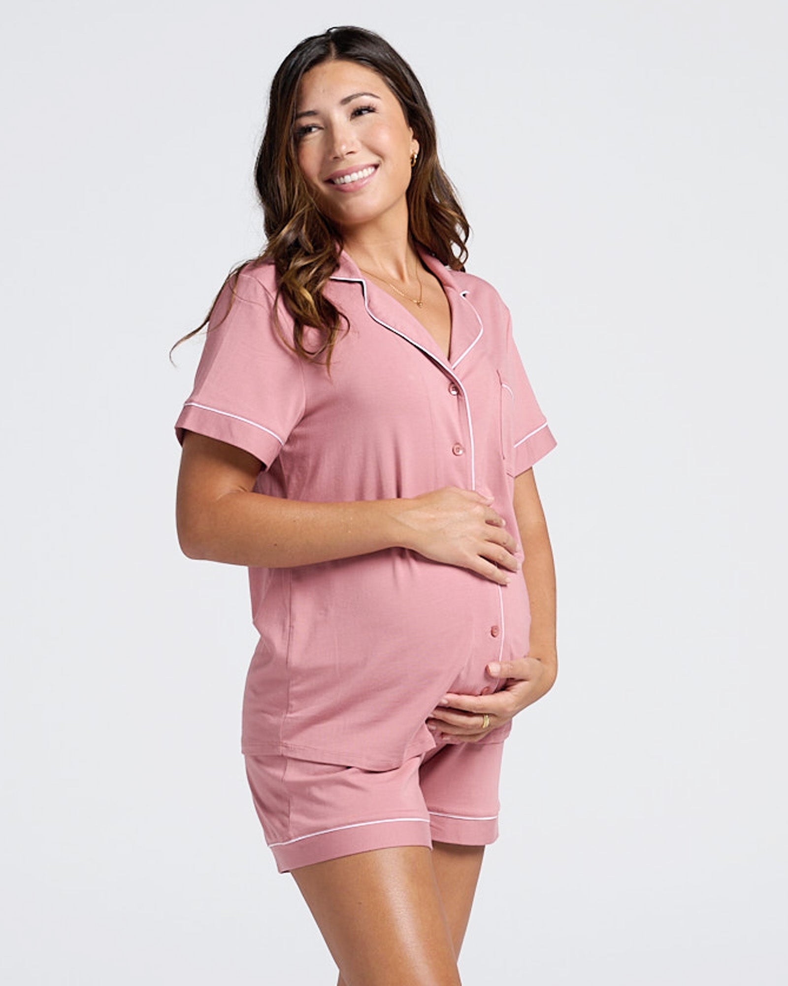 Woman wearing a pink bamboo maternity pajama setbackground