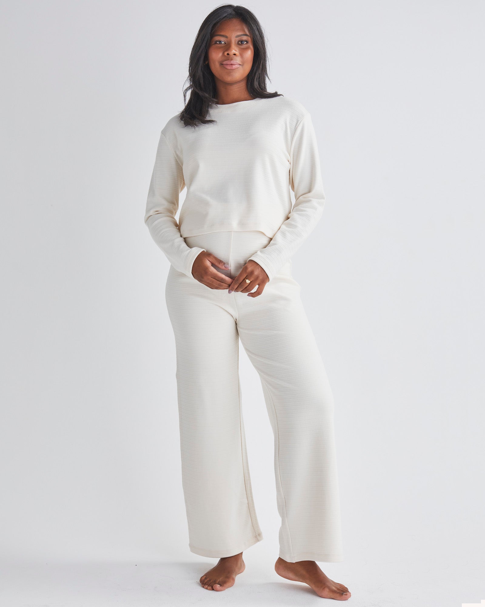 A pregnant Woman Wearing 2-piece Maternity Winter Lounge Set in Cream White from Angel Maternity