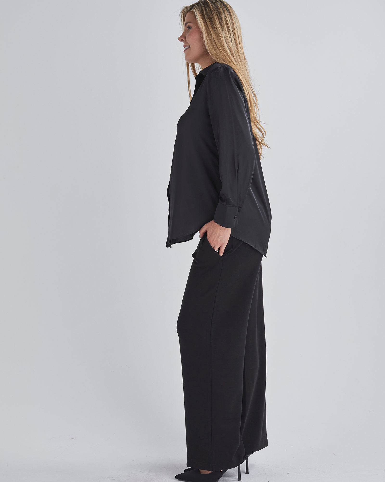 Side view-This maternity work shirt has long sleeves with a button up cuff which you can dress it up or down, this versatile piece offers comfort and sophistication for any occasio from Angel Maternity