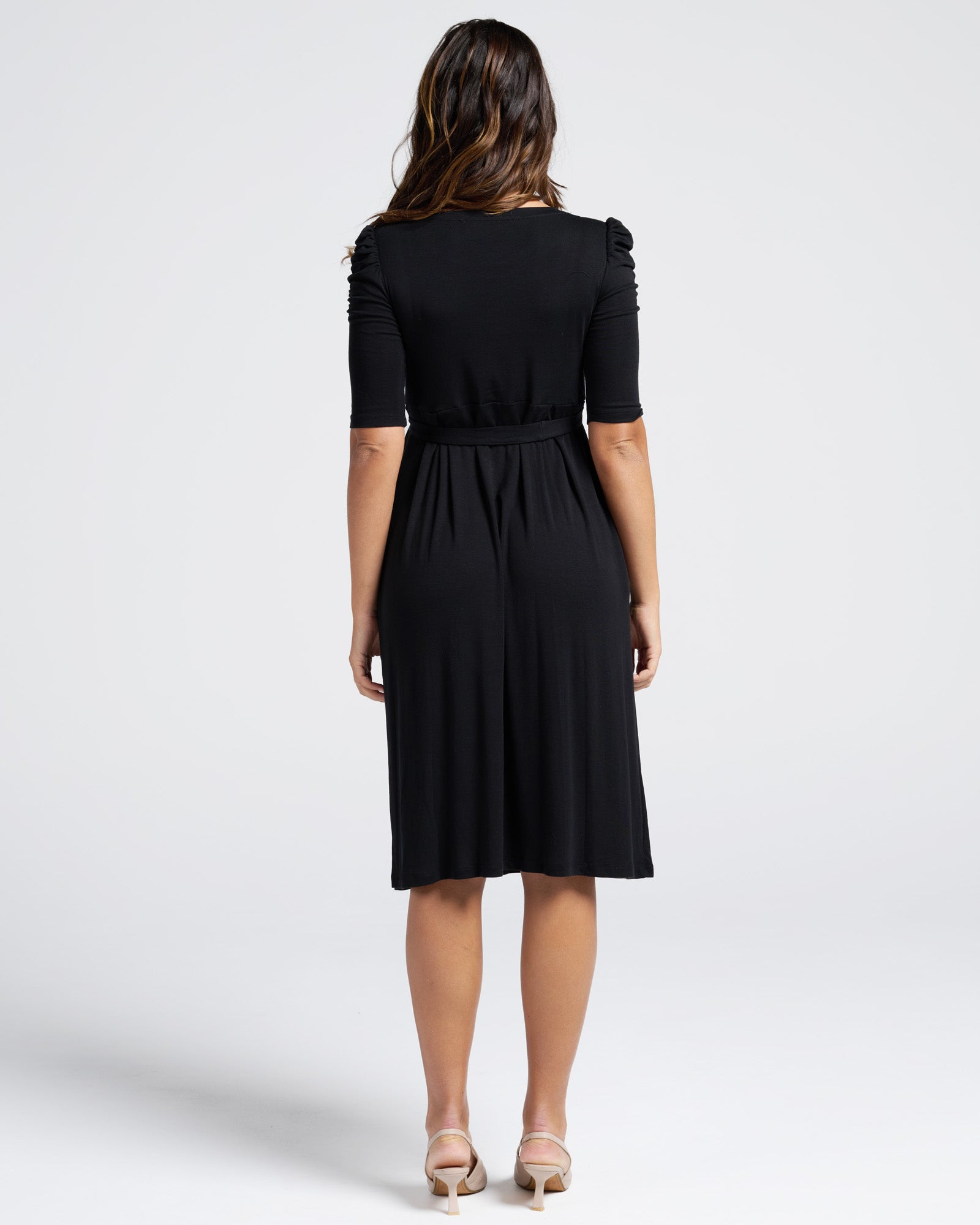 Woman wearing a black dress on a white background