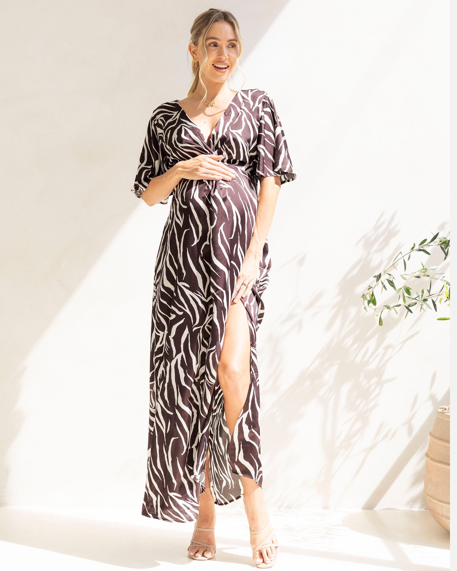 Pregnant woman wearing a zebra print maternity dress as evening outfit