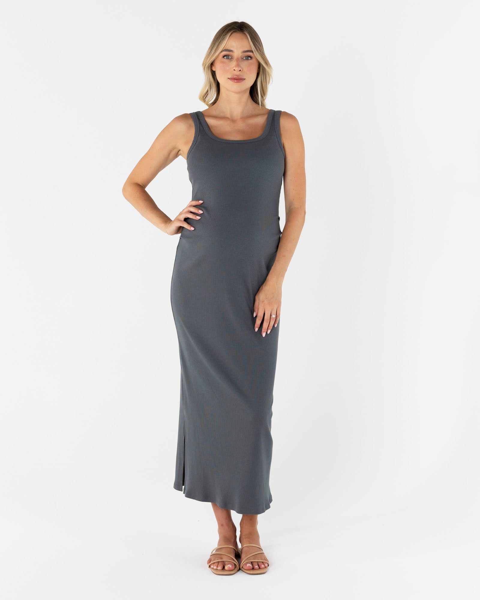 Woman wearing a gray sleeveless essential rib dress dress on a white background