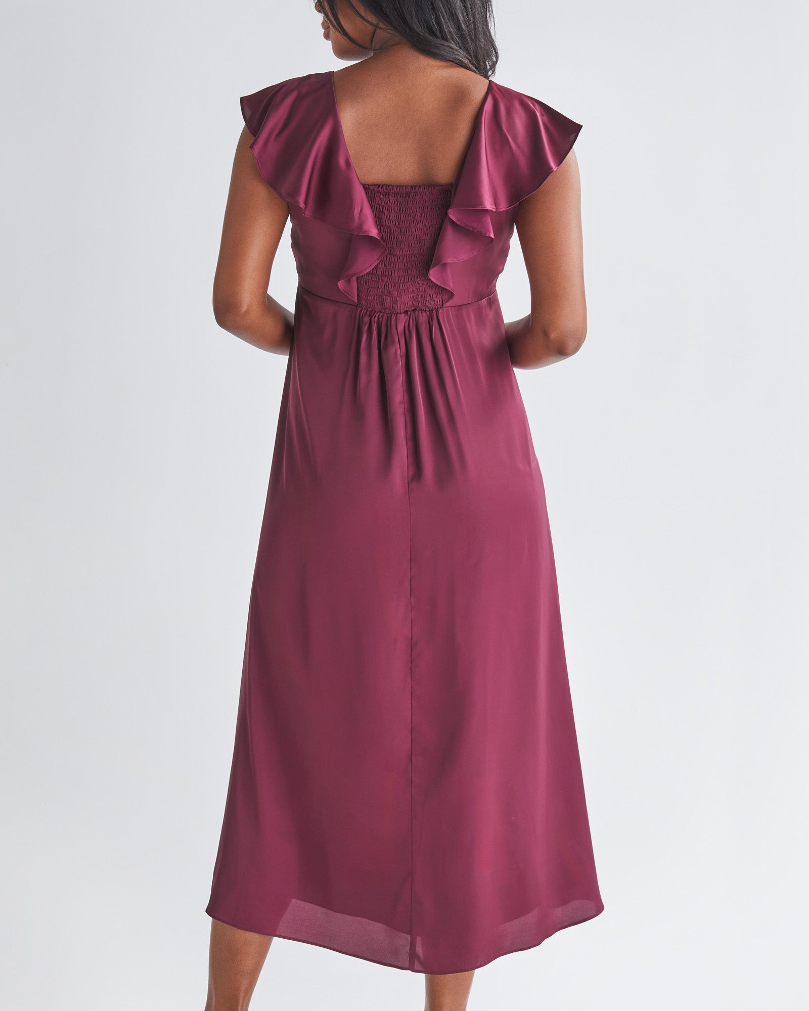 Back View - A Pregnannt Woman Wearing Mika Maternity Evening Ruffle Dress in Wine from Angel Maternity.