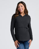 Woman wearing a black layered maternity  hoodie with nursing access