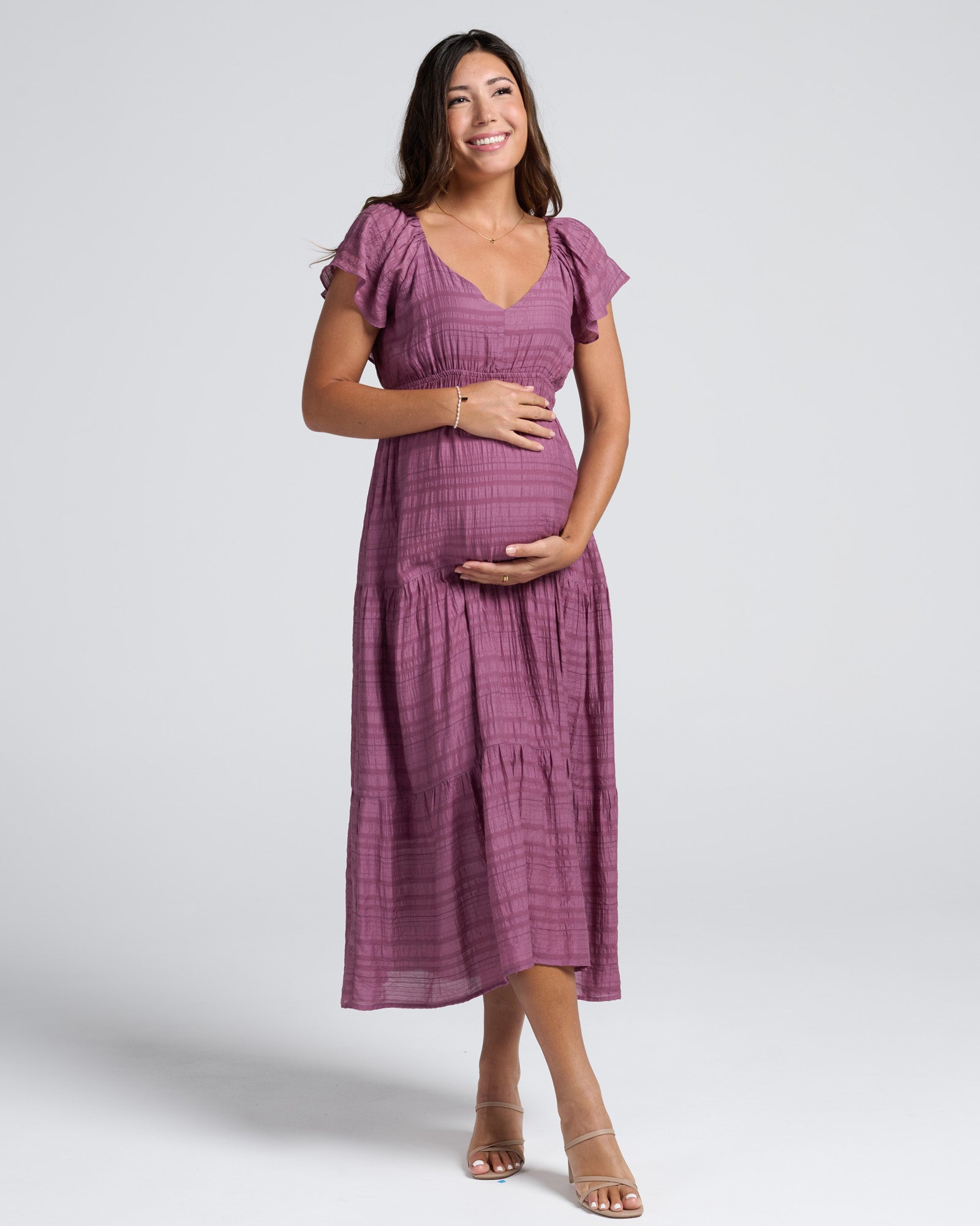 Woman wearing a purple dress on a white background