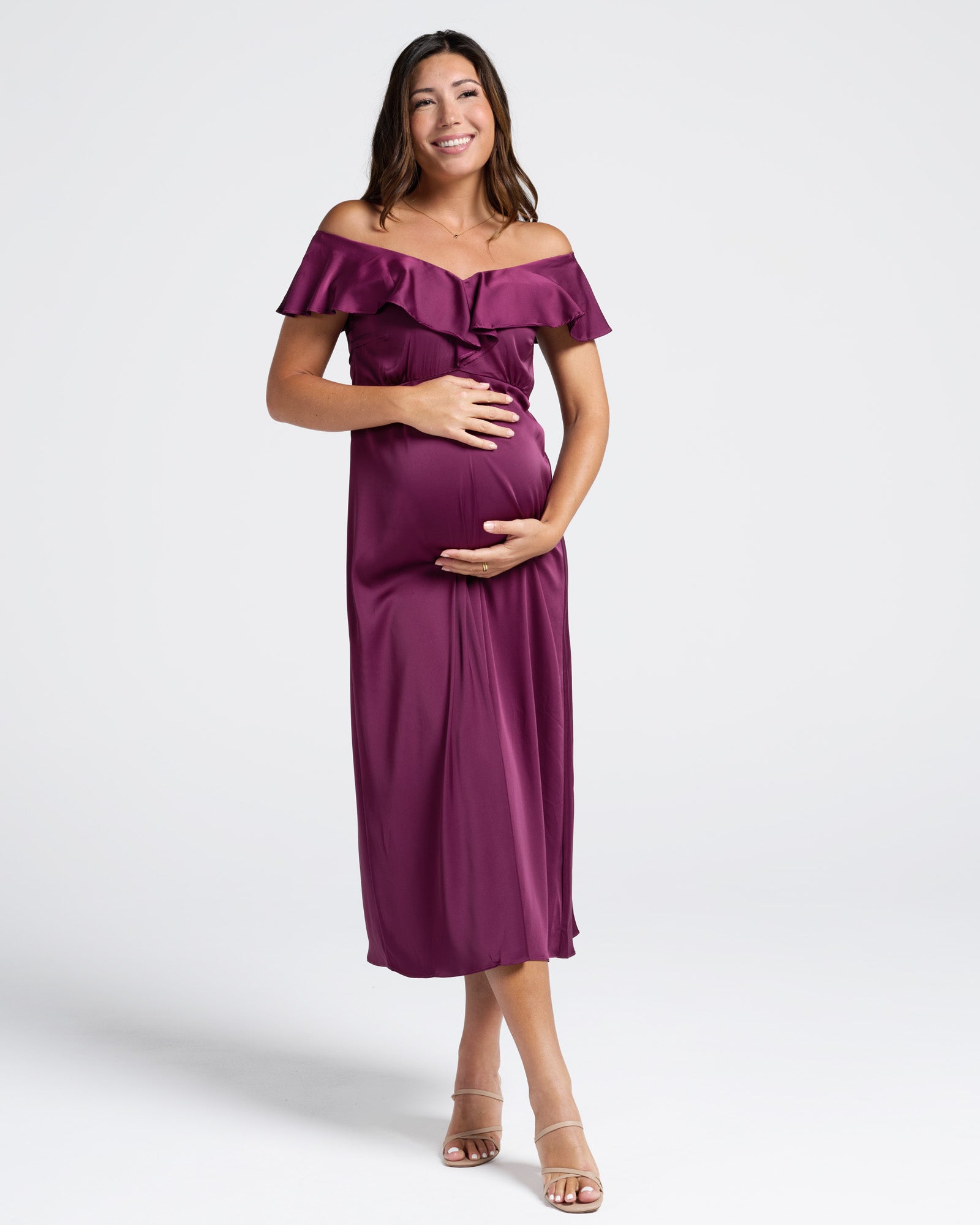 Woman wearing a purple off-shoulder maternity evening dress