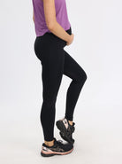 Main view - A Pregnant Woman in Full Length Black Maternity Sports Leggings with Side Pockets (6581573386343)