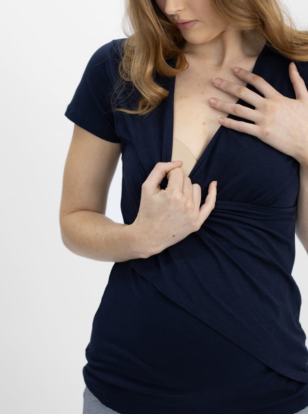 A woman in maternity nursing crossover bamboo tee, feeding (4331798233191)