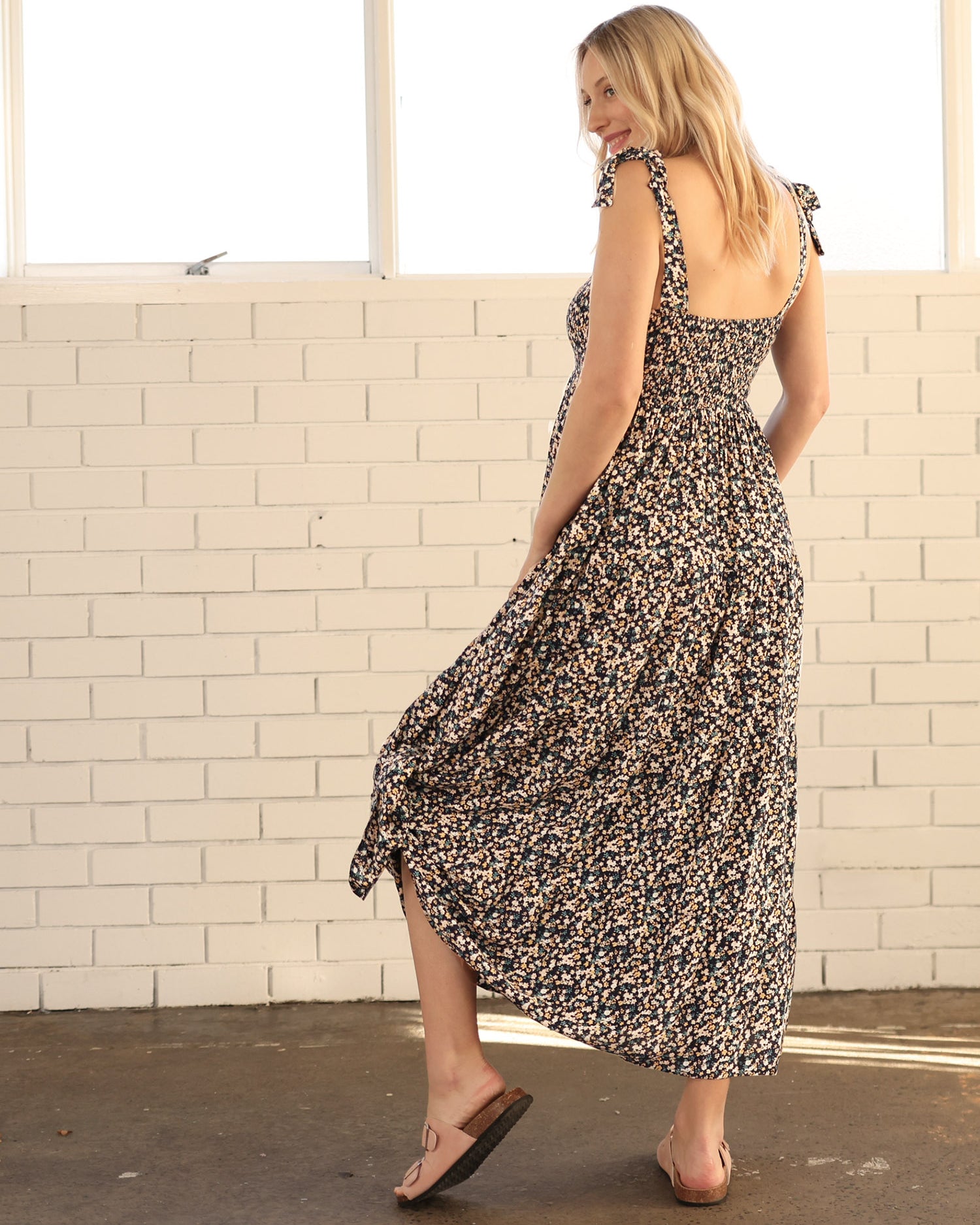 Back View - A pregnant Woman in Floral Long Maternity Maxi Dress in Navy Floral Print