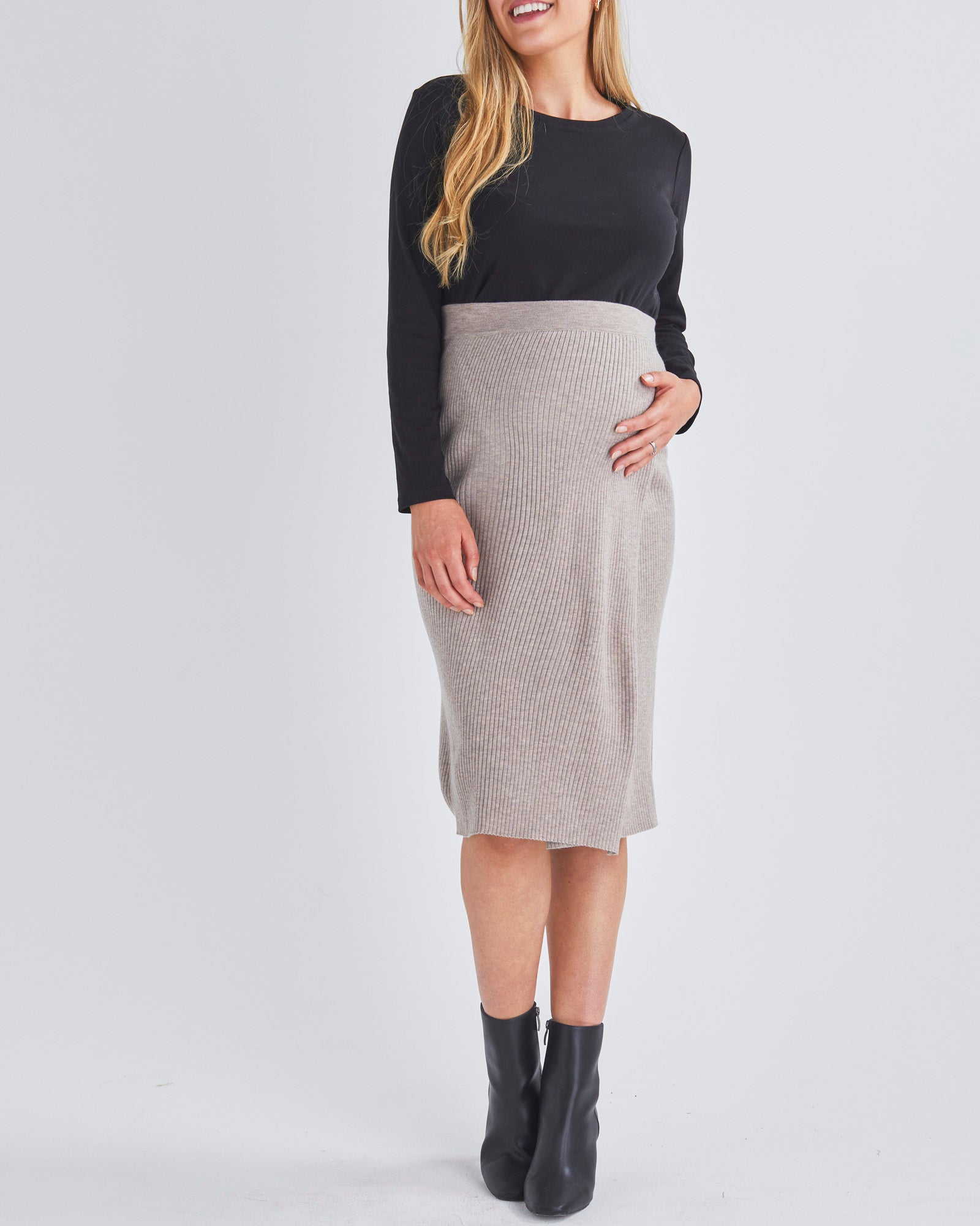 A Pregnant Woman Wearing Long Sleeve Cotton Black Maternity Crop Top and Skirt from Angel Maternity
