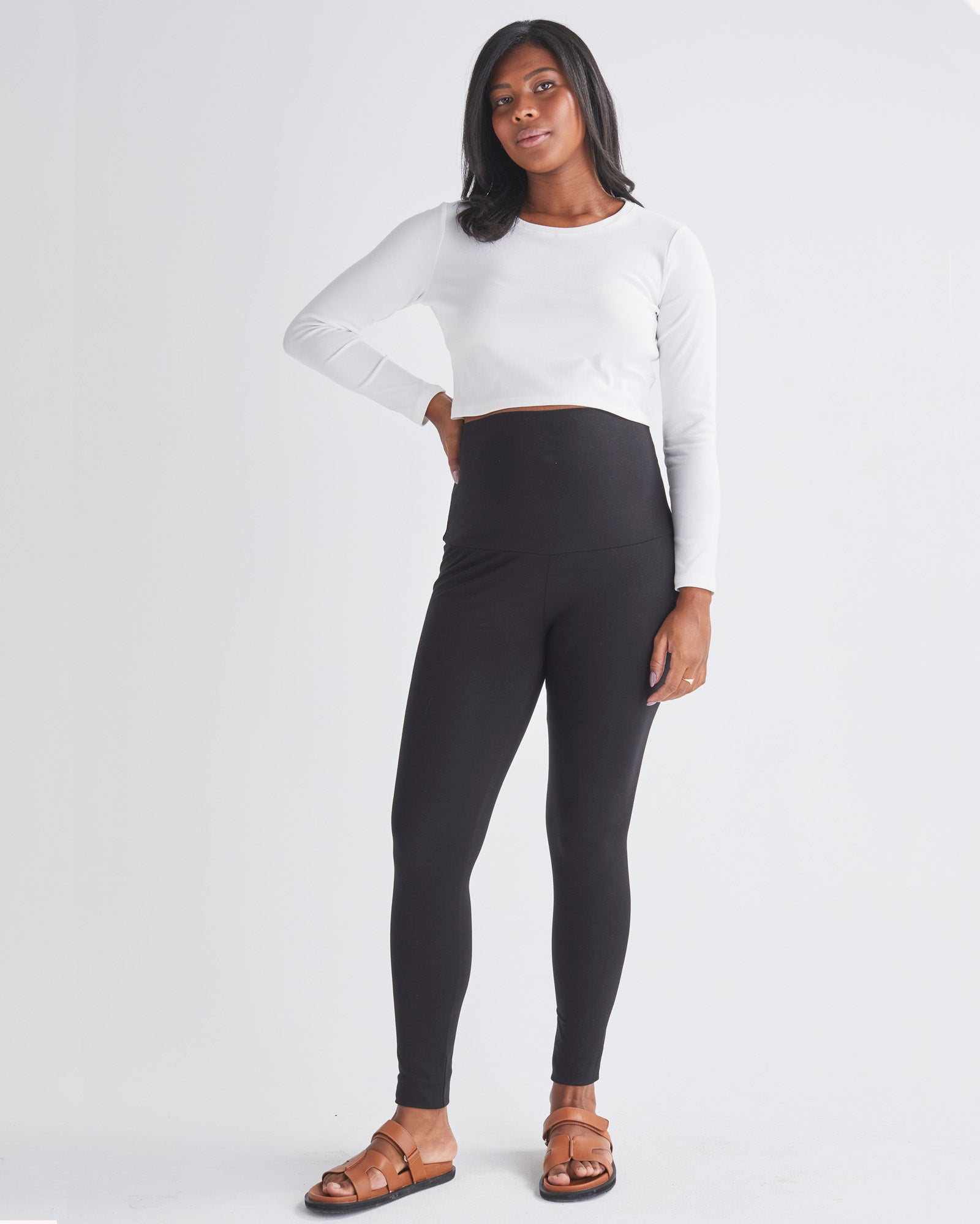 Full Front View - A Pregnant Woman Wearing Maternity Long Sleeve Cotton Crop Tee in White & Black Leggings from Angel Maternity