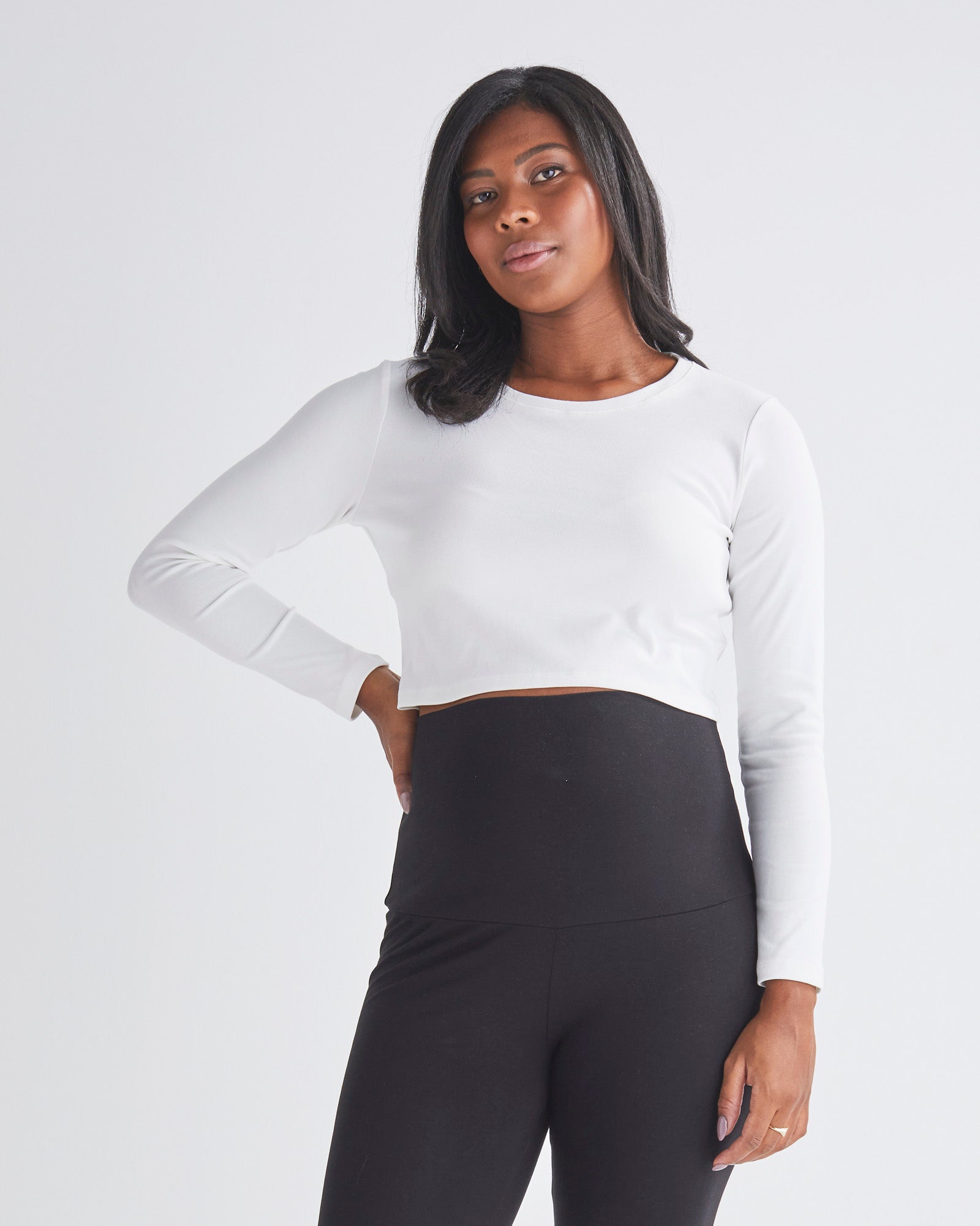 A Pregnant Woman Wearing Maternity Long Sleeve Cotton Crop Tee in White from Angel Maternity