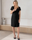 Woman wearing a black dress in a minimalistic room.