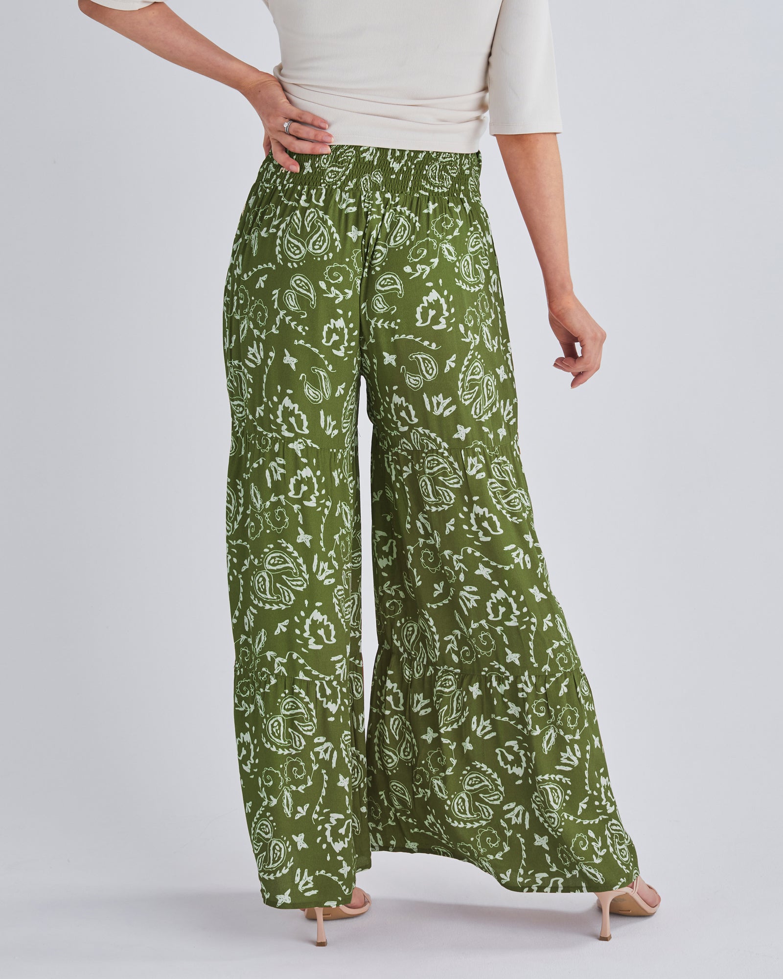Back View - A pregnant Woman Wearing Stacie Wide Leg Khaki Maternity Pants in Paisley Print from Angel Maternity