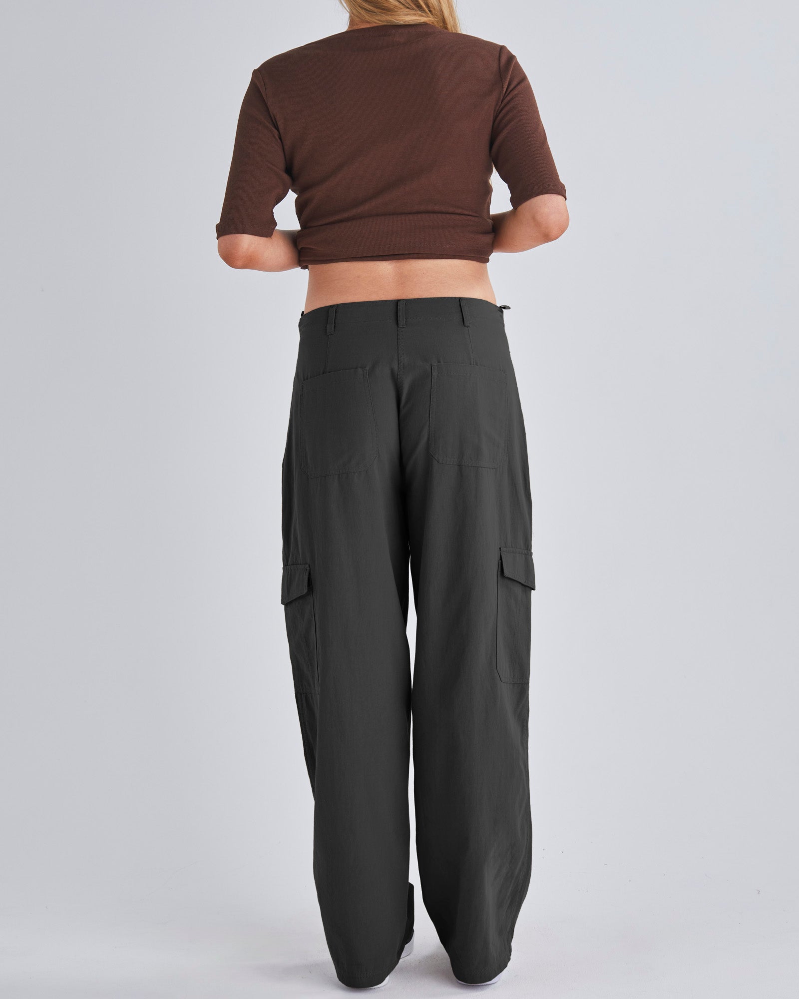 Back View - A Pregnant Woman Wearing Black Maternity Cotton Cargo Pants from Angel Maternity