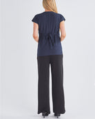 Back View - A Pregnant Woman Wearing Short Sleeve Nursing Friendly Maternity Crossover Navy Work Top  from Angel Maternity