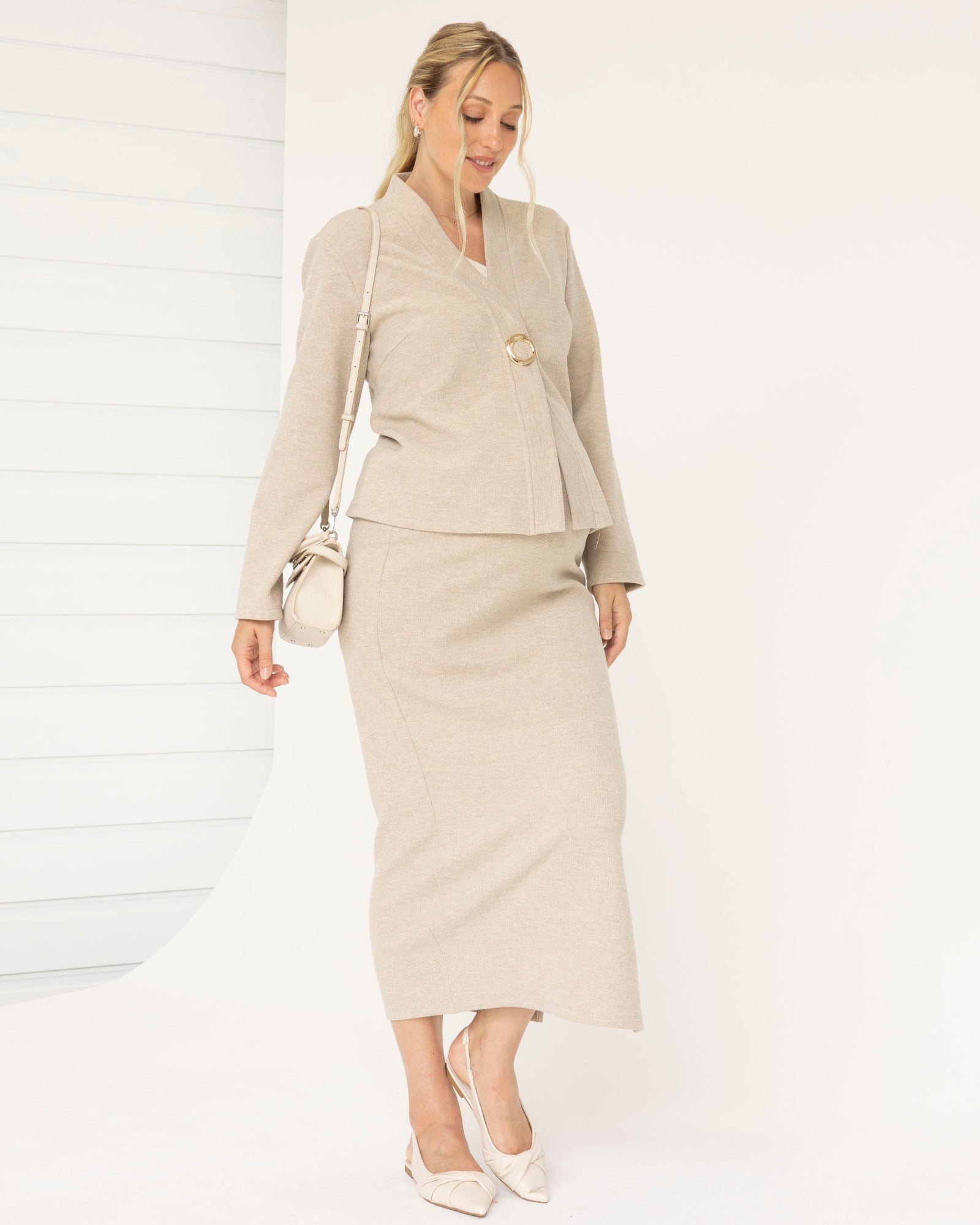 Woman wearing a beige suit with a white background