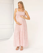 Woman wearing a pink maternity dress in babyshower
