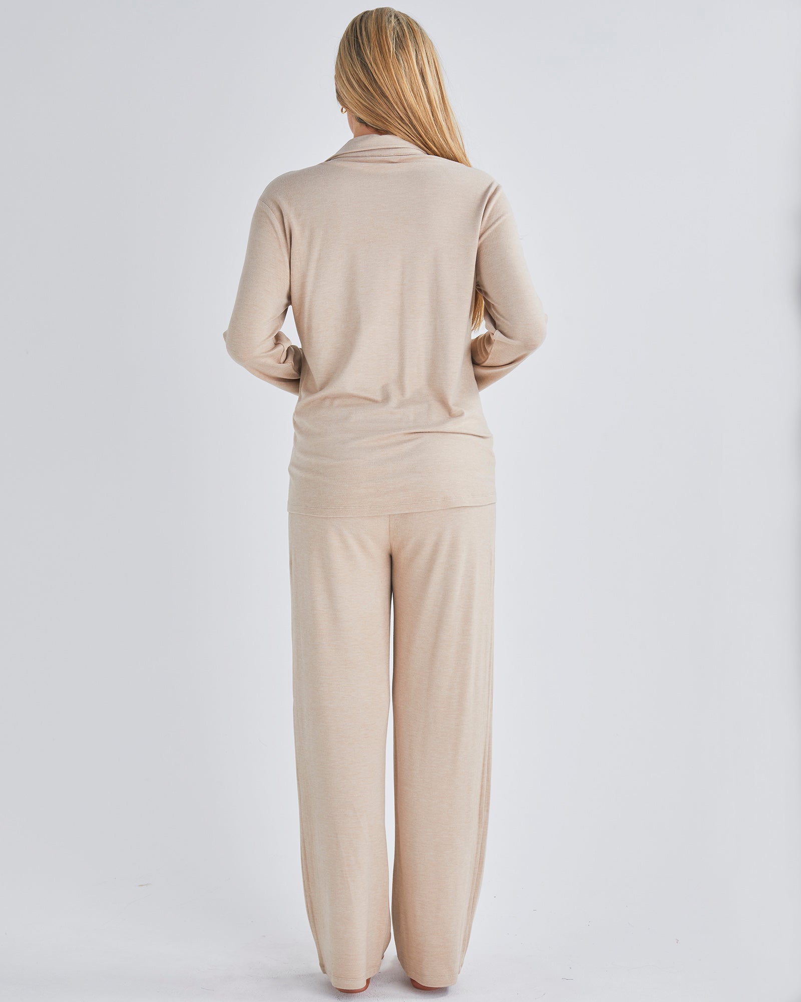 Back view - A pregnant woman wearing button front nursing freindly pyjama set in pink from Angel Maternity.