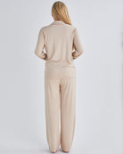 Back view - A pregnant woman wearing button front nursing freindly pyjama set in pink from Angel Maternity.