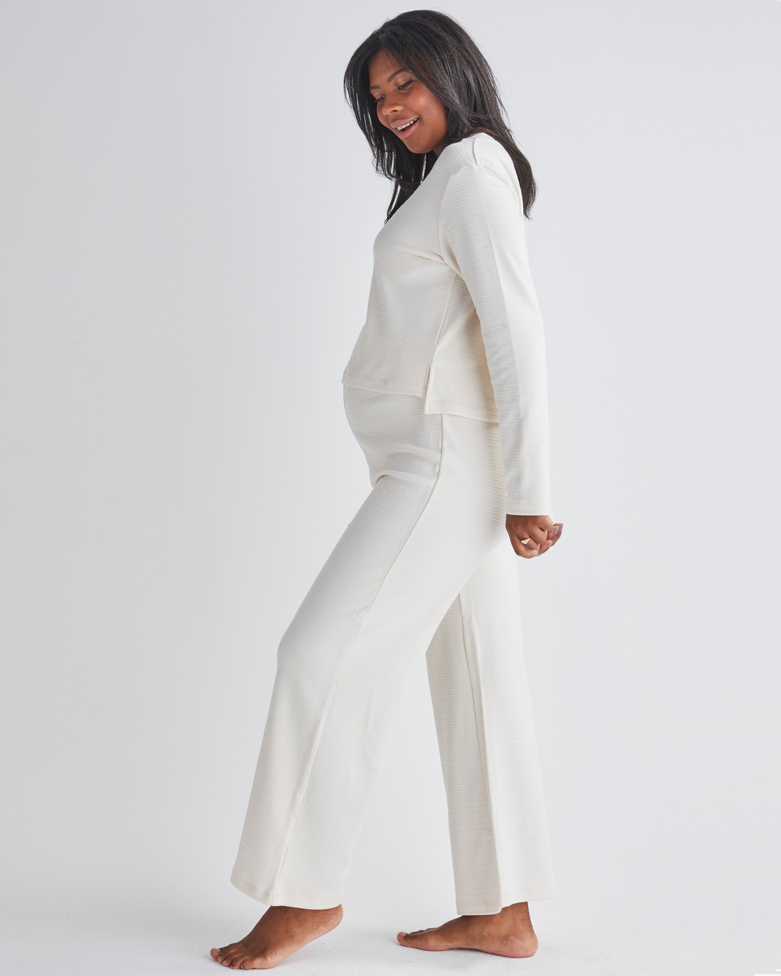 Side View - A pregnant Woman Wearing 2-piece Maternity Winter Lounge Set in Cream White from Angel Maternity