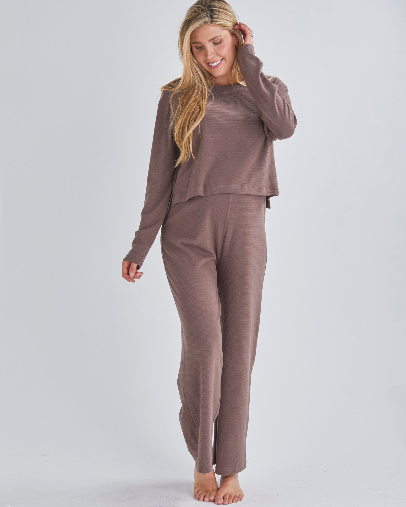 A pregnant Woman Wearing 2-piece Maternity Winter Lounge Set (long sleeve crop top & pants) &  in Taupe from Angel Maternity