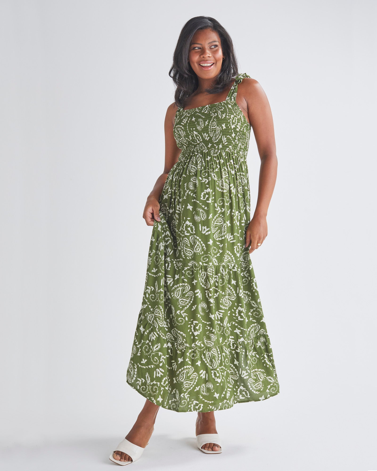 A Pregnant Woman Wearing Lilliana Maternity Green Maxi Dress in Paisley Print from Angel Maternity