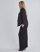 Side view-This maternity work shirt has long sleeves with a button up cuff which you can dress it up or down, this versatile piece offers comfort and sophistication for any occasio from Angel Maternity