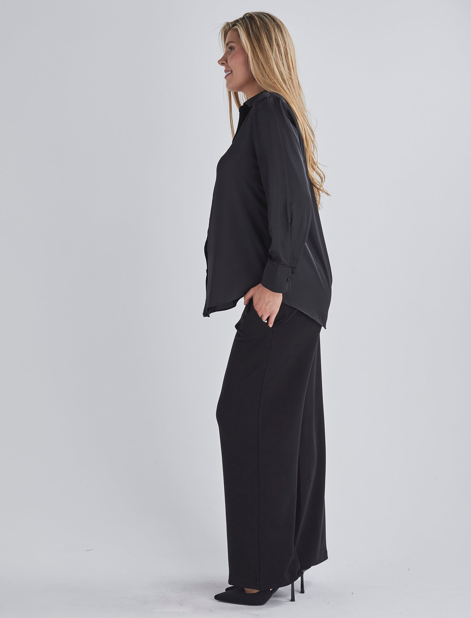 Side view-This maternity work shirt has long sleeves with a button up cuff which you can dress it up or down, this versatile piece offers comfort and sophistication for any occasio from Angel Maternity