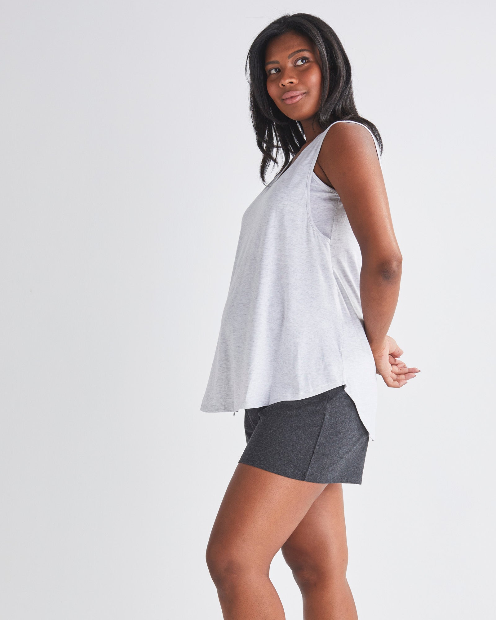 Side View - A Pregnannt Woman Wearing 2-piece Maternity/Nursing Pyjama Set - Top & Shorts from Angel Maternity.