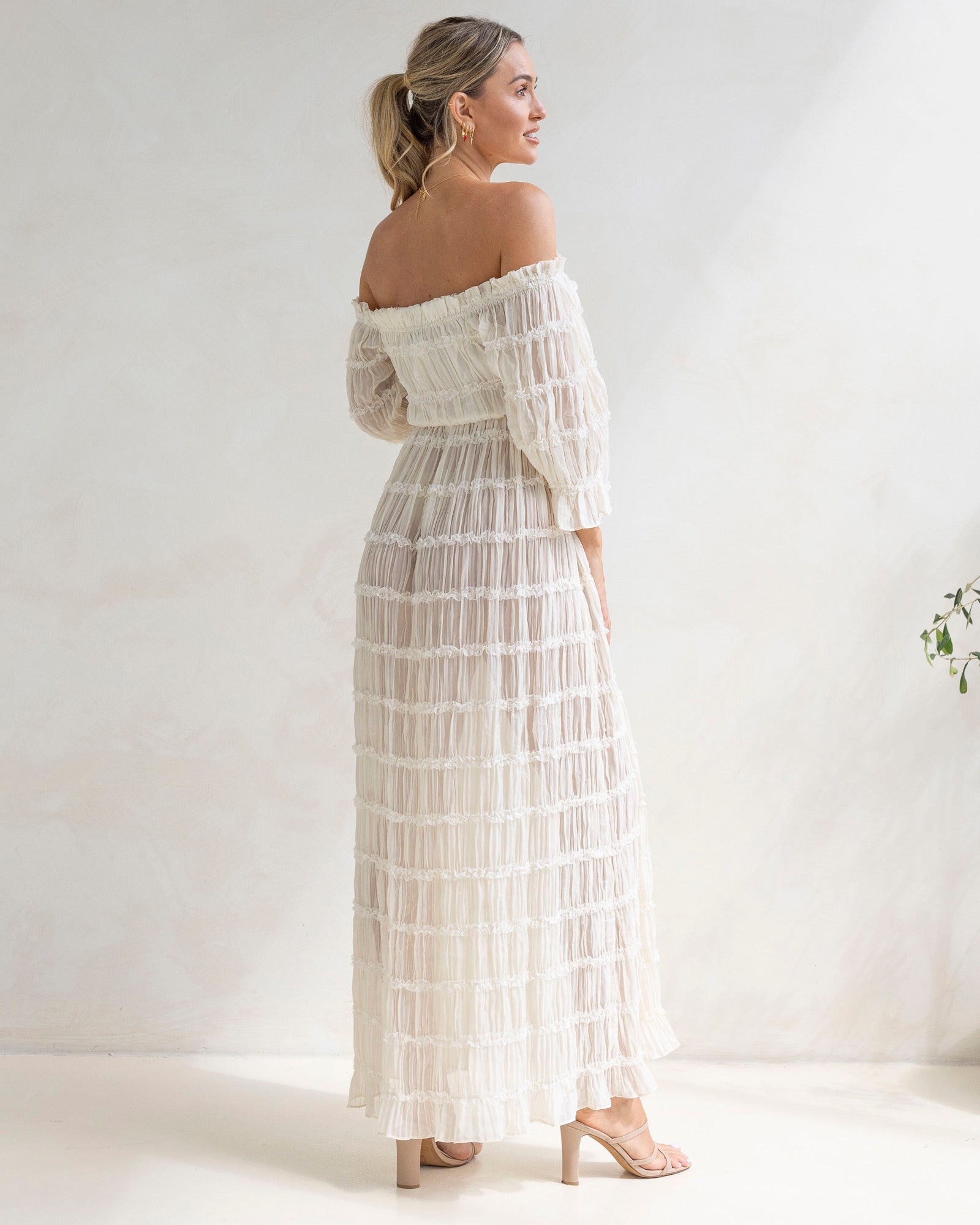 Woman wearing a white off-shoulder photo shoot dress 