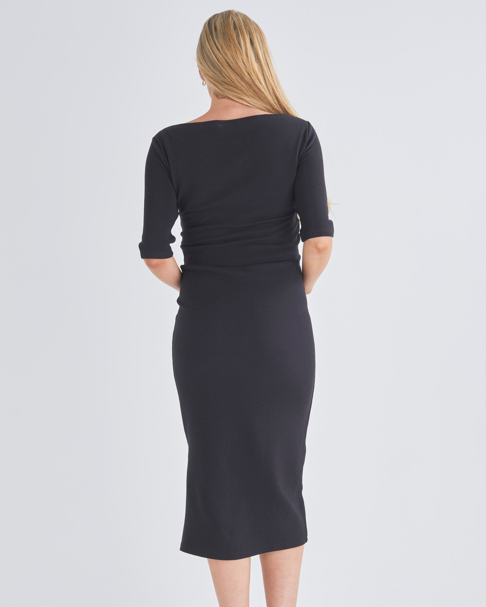 Back View - A Pregnannt Woman Wearing Athena Maternity Work/Day Smart Casual Black Outfit Set - a Pencil Midi Skirt & a Cross Over Short Top from Angel Maternity Australia.