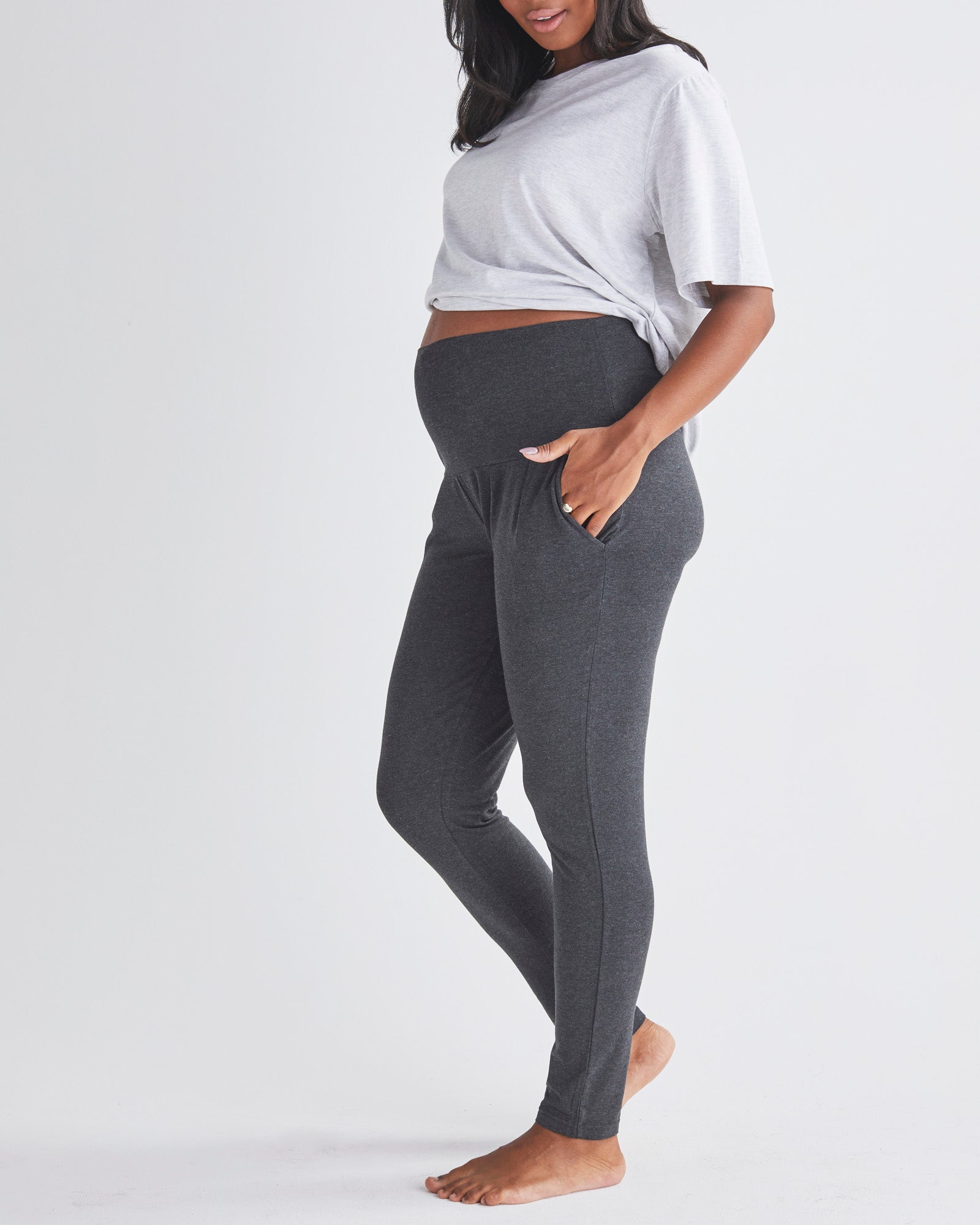 Side View - A Pregnannt Woman Wearing Eden Ultra Soft Maternity Lounge Pants in Charcoal from Angel Maternity.