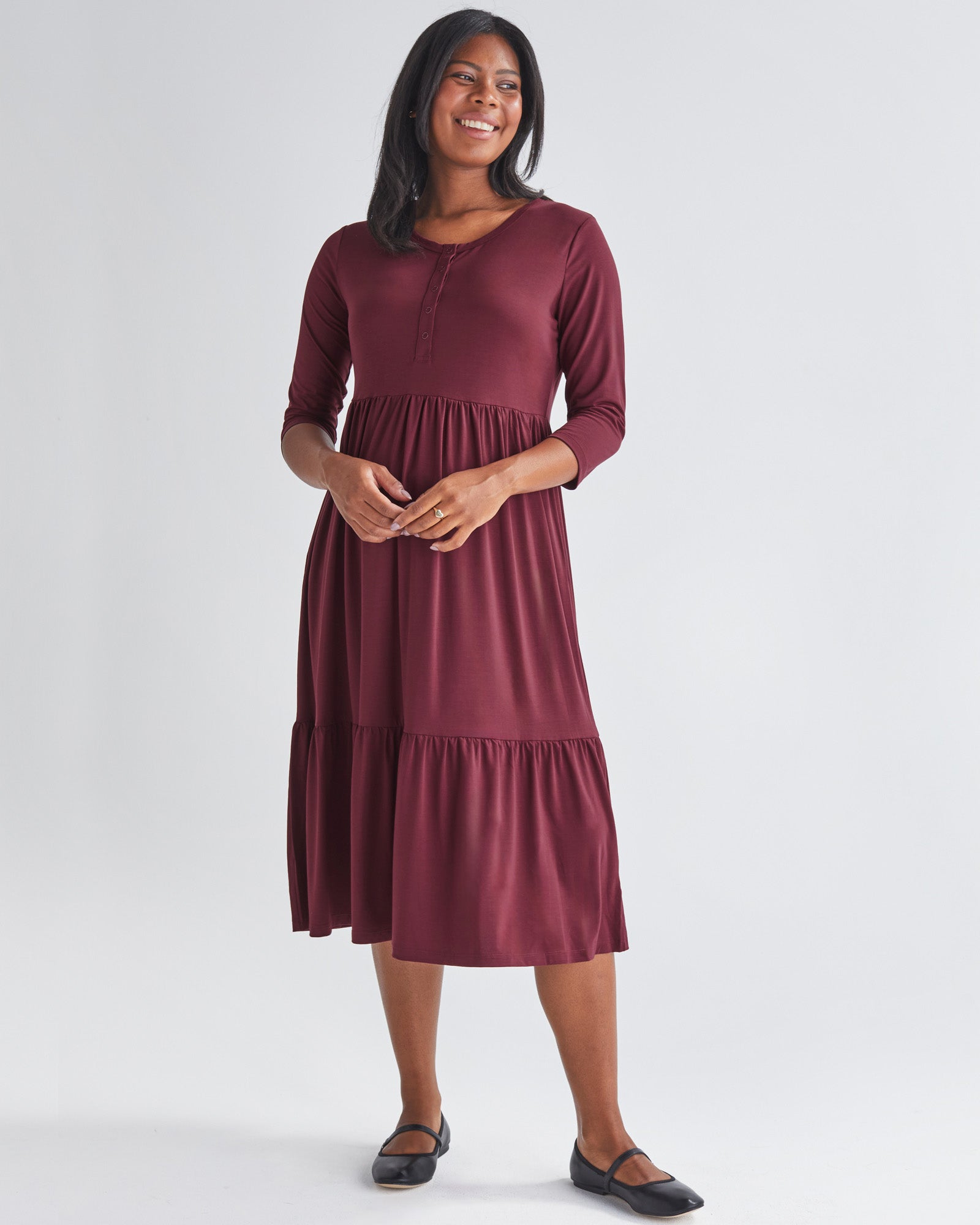 A Pregnannt Woman Wearing Tiered Maternity Midi Dress in Burgundy from Angel Maternity.