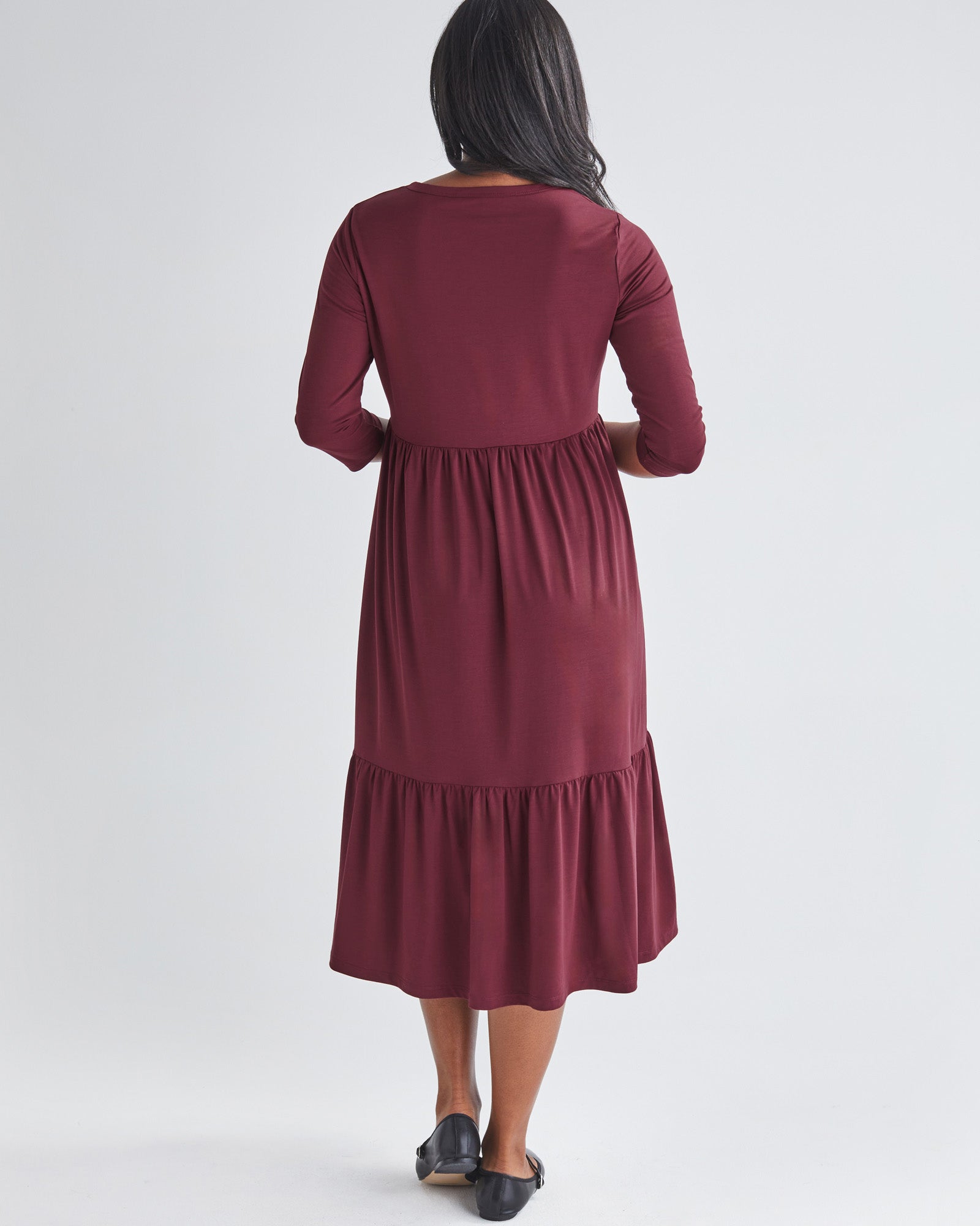 Back View - A Pregnannt Woman Wearing Tiered Maternity Midi Dress in Burgundy from Angel Maternity.
