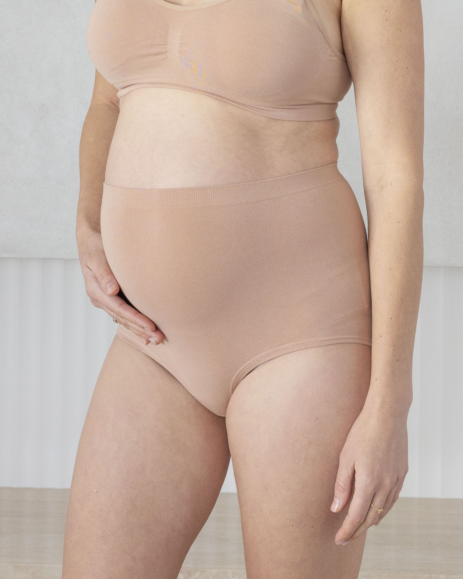 Beige shapewear worn by a person on a neutral background