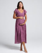 Woman wearing a purple dress on a white background