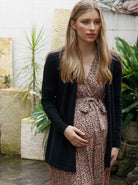A woman in black angel maternity roll collar knitted waist tie cardigan, front (9984033350)
