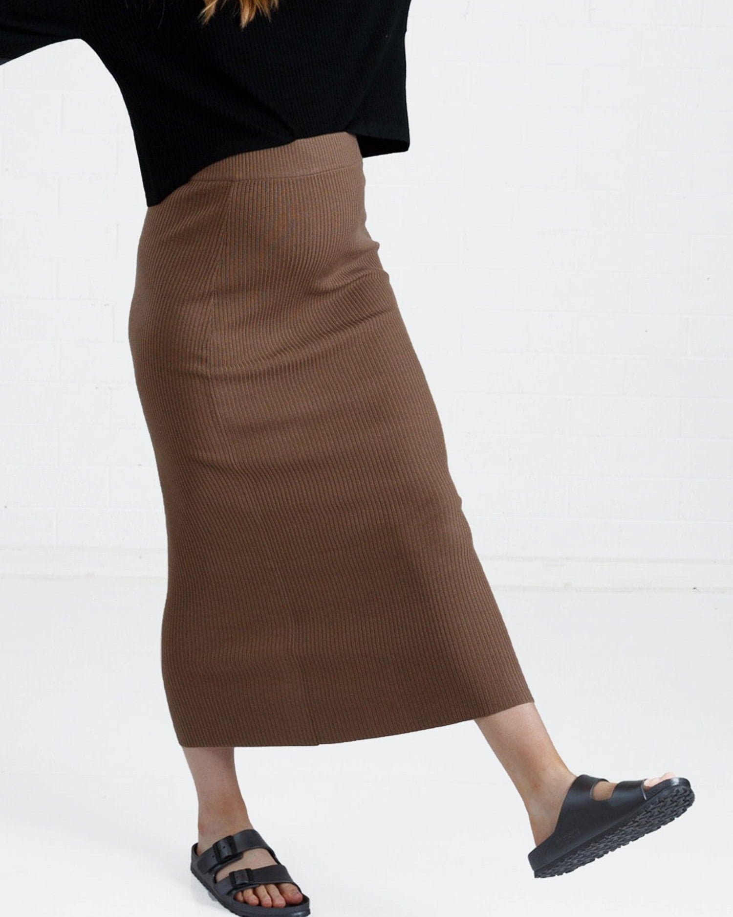a woman in brown maternity angel maternity wool blend knit skirt with side split, front (6651643461735)